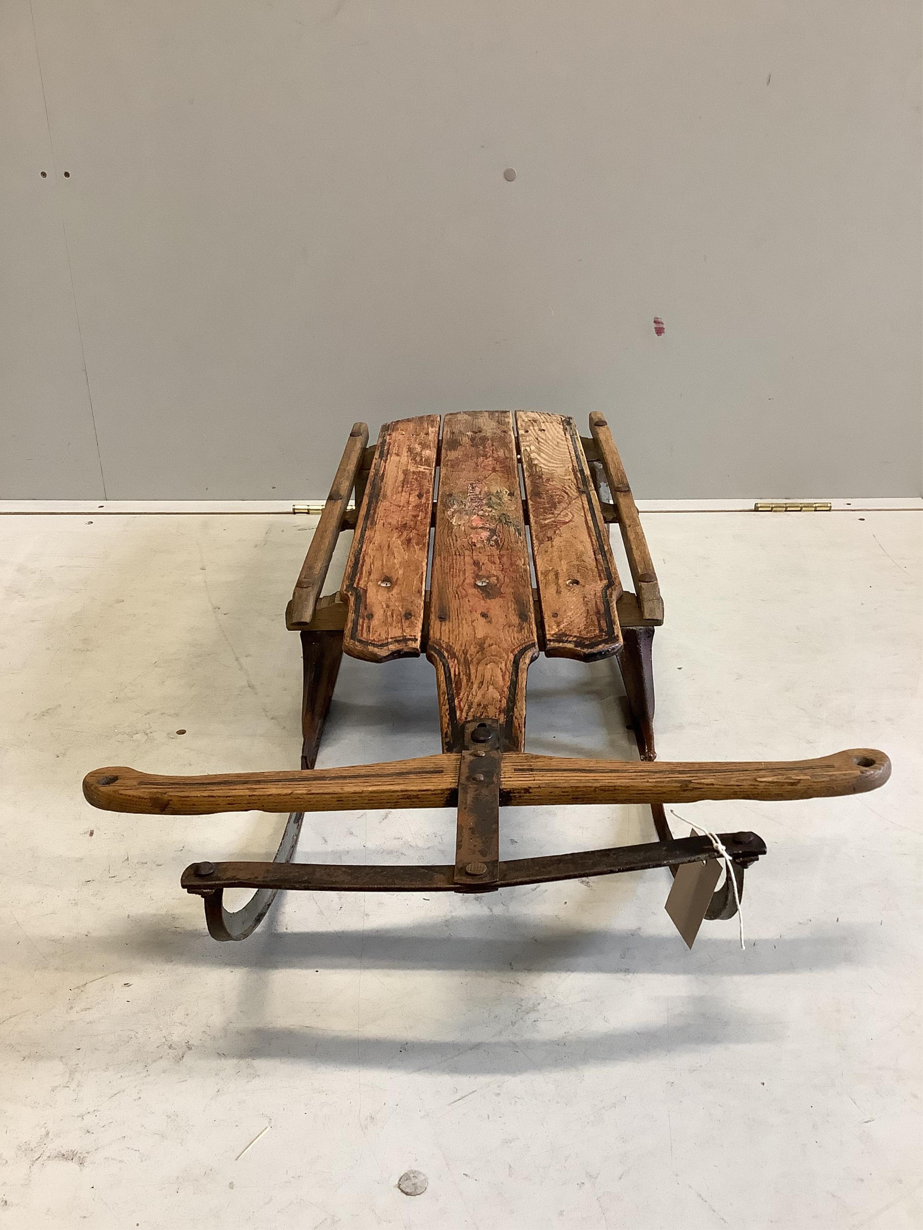 A painted sledge, width 53cm, depth 107cm, height 17cm